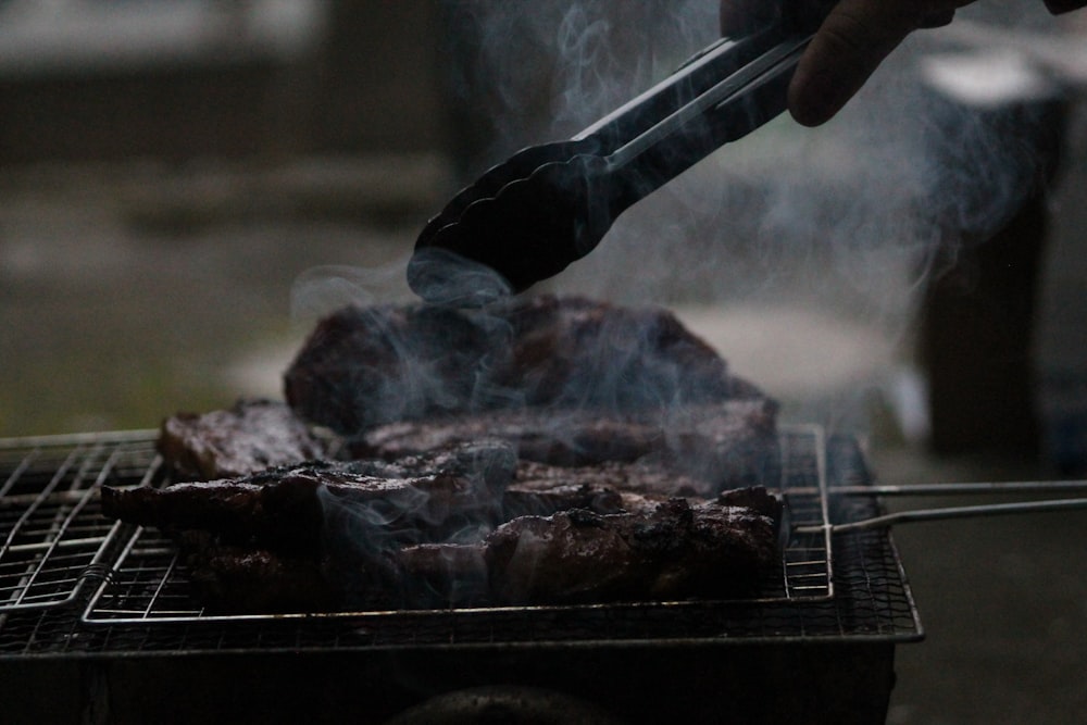 person grilling barbecue