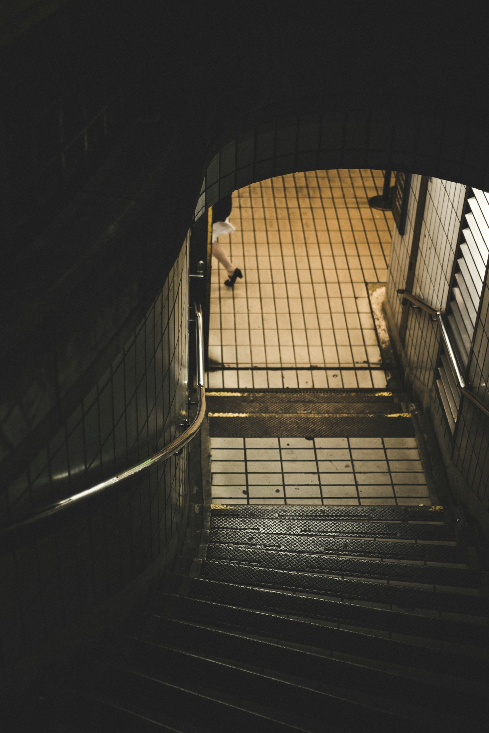 Nikon D800 + AF Nikkor 50mm f/1.8 sample photo. Person walking near stairs photography