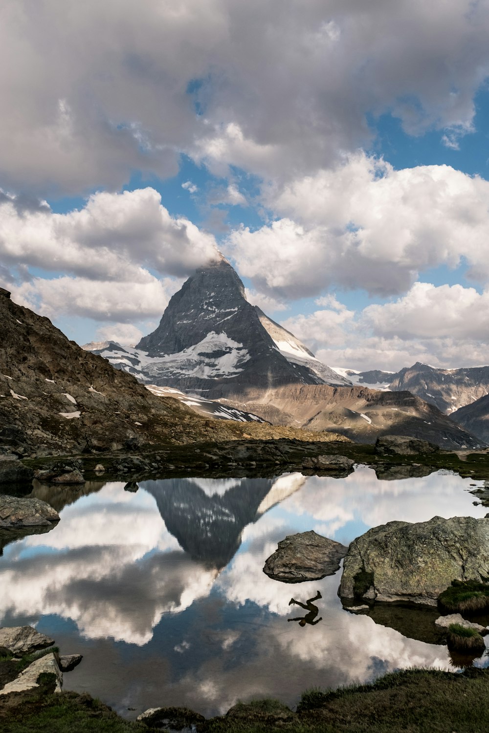 Specchio d'acqua calmo vicino alla montagna durante il giorno