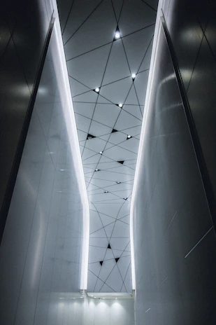 Modern interior showing a sleek drywall ceiling with integrated decorative lighting.