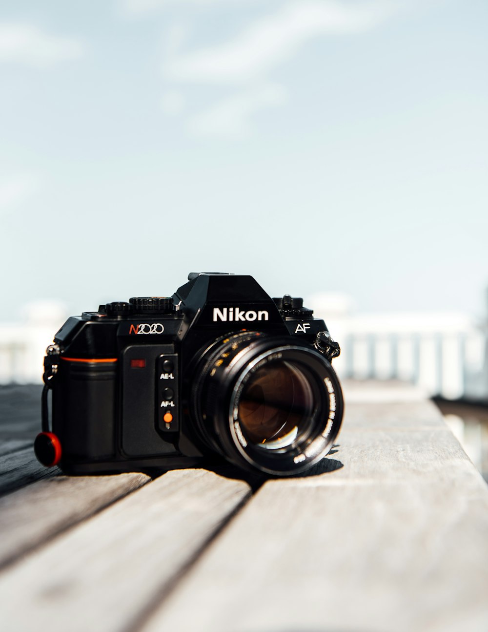 black nikon dslr camera on brown wooden table