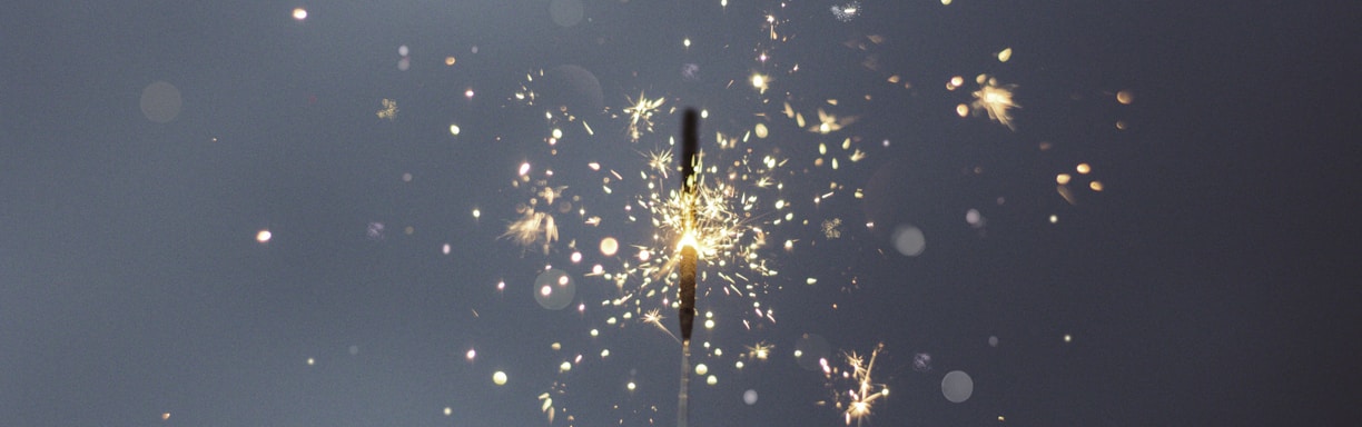 person holding lighted sparklers