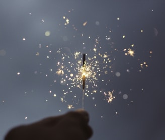 person holding lighted sparklers