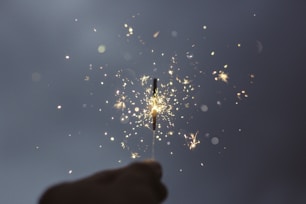person holding lighted sparklers