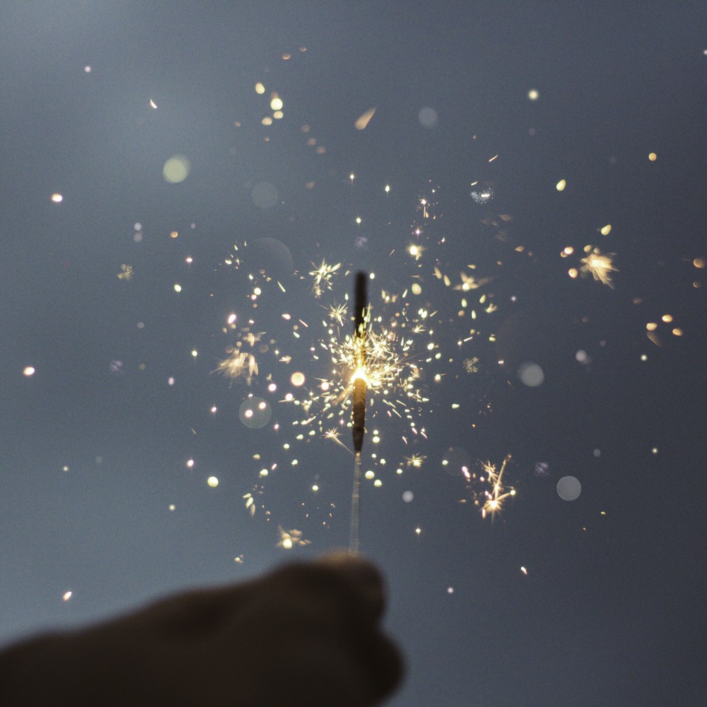 person holding lighted sparklers