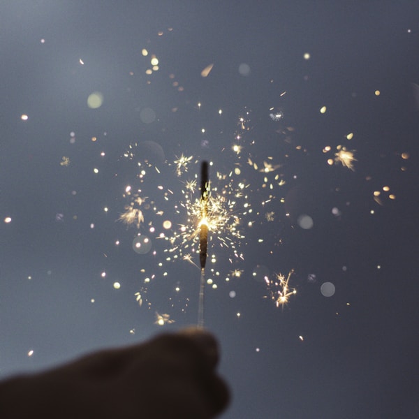 person holding lighted sparklers