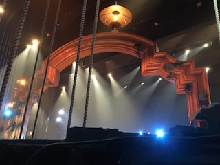 A close-up of a spooky stage setup featuring fog and haunted house props at night.