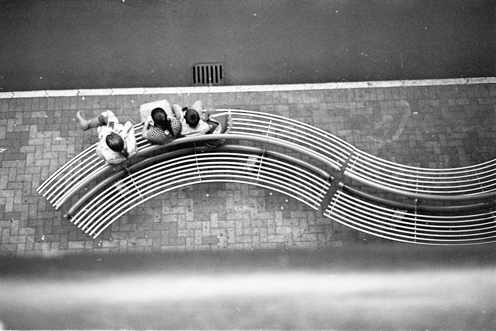 Photographie aérienne de personnes assises sur un banc