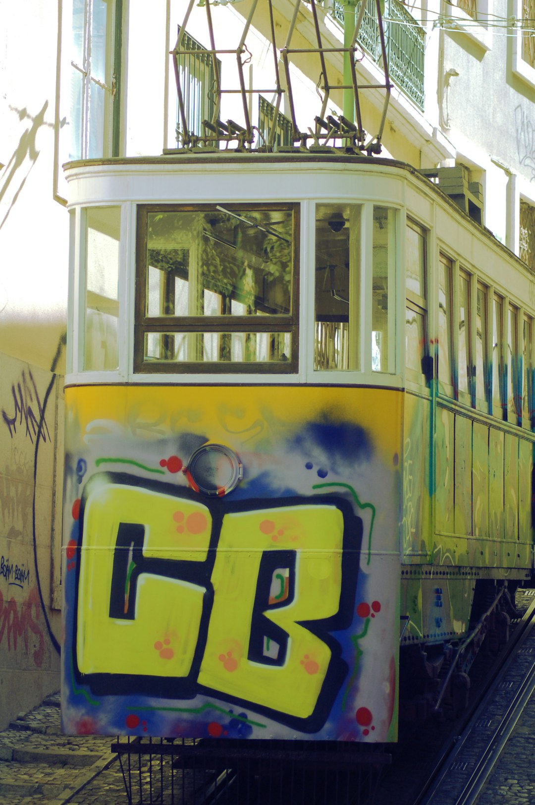 yellow and blue train with graffiti