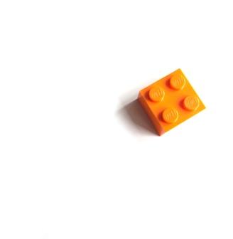 orange mega blocks toy on white surface
