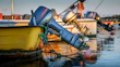 Sleek outboard motors displayed on a boat dock with water reflections