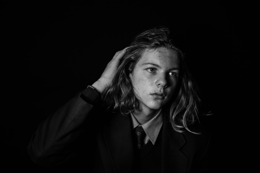 man wearing black blazer on black background