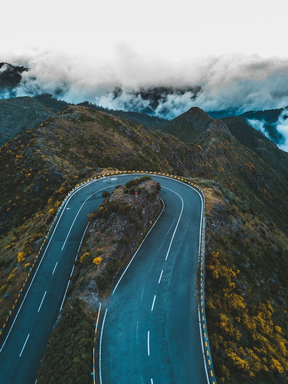 aerial photography of mountain pass under white clouds
