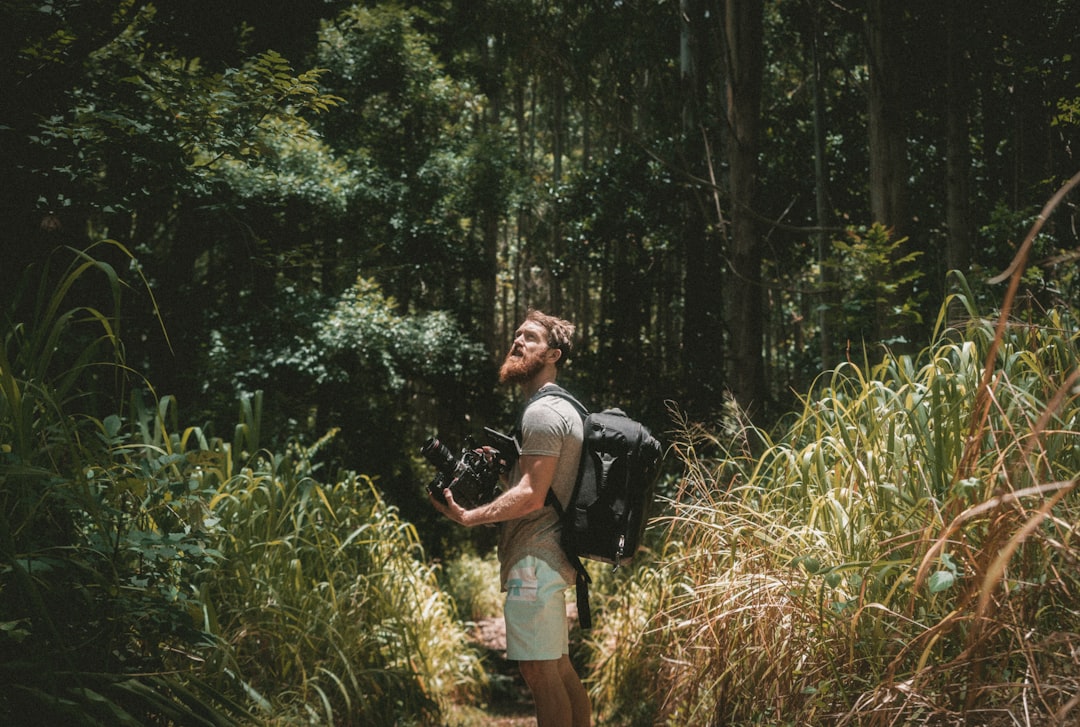 man holding camera in the forest