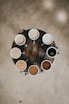 flat lay photography of eight coffee latte in mugs on round table