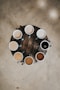 flat lay photography of eight coffee latte in mugs on round table