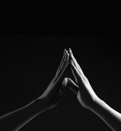 person's hands forming triangle
