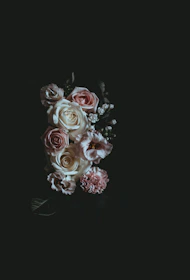An elegant arrangement of black lace intertwined with soft pink satin ribbons, evoking intimacy and refinement.