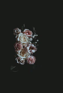 An elegant arrangement of black lace intertwined with soft pink satin ribbons, evoking intimacy and refinement.