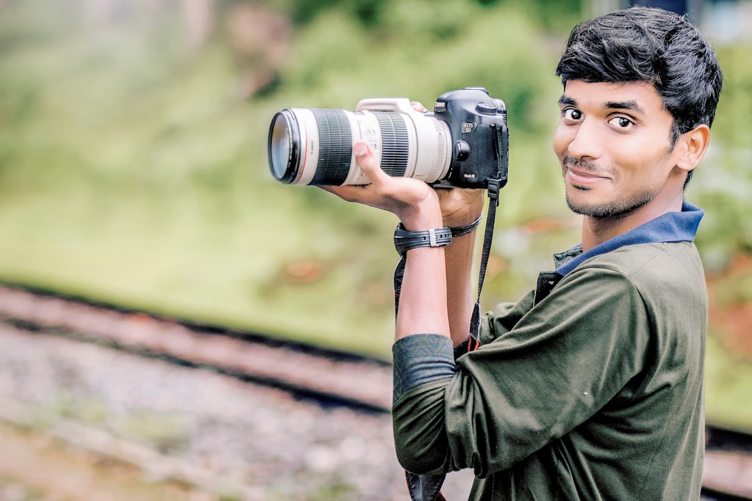 man taking photo in selective focus photography