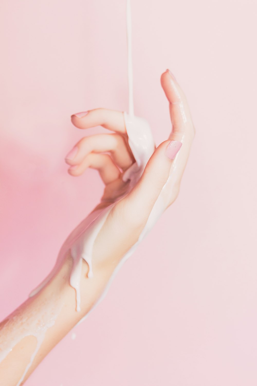 a woman's hand holding a bottle of lotion