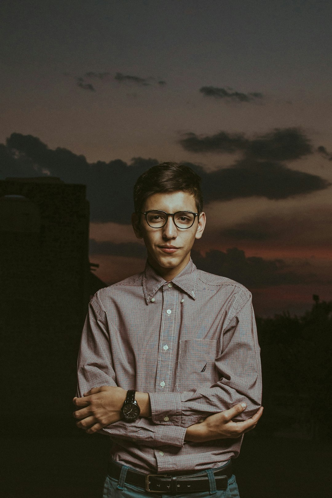 man in white and blue plaid button up shirt wearing black framed eyeglasses