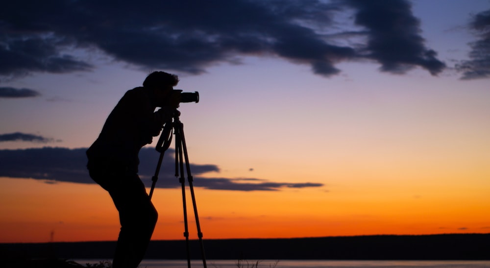 silhouette of man taking picture