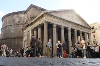 Image of a historic Roman building with a 'sold' sign in front.