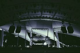 Stage setup with large speakers and sound array at a massive outdoor concert