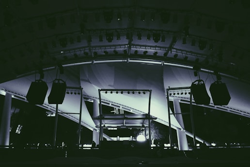 Stage setup with lighting and sound equipment outdoors.