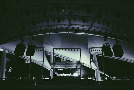 Professional event setup with sound, lighting, tents, and staff in action.