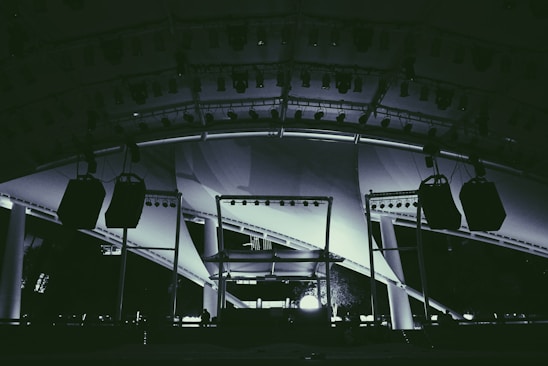 A dynamic event setup featuring lights, sound equipment, and a stage ready for a performance.