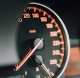 closeup photo of black analog speedometer