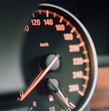 closeup photo of black analog speedometer