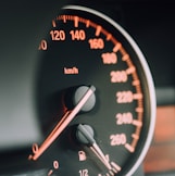 closeup photo of black analog speedometer