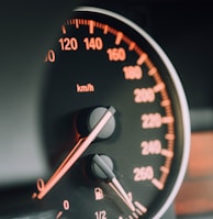 closeup photo of black analog speedometer