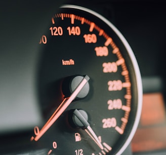 closeup photo of black analog speedometer