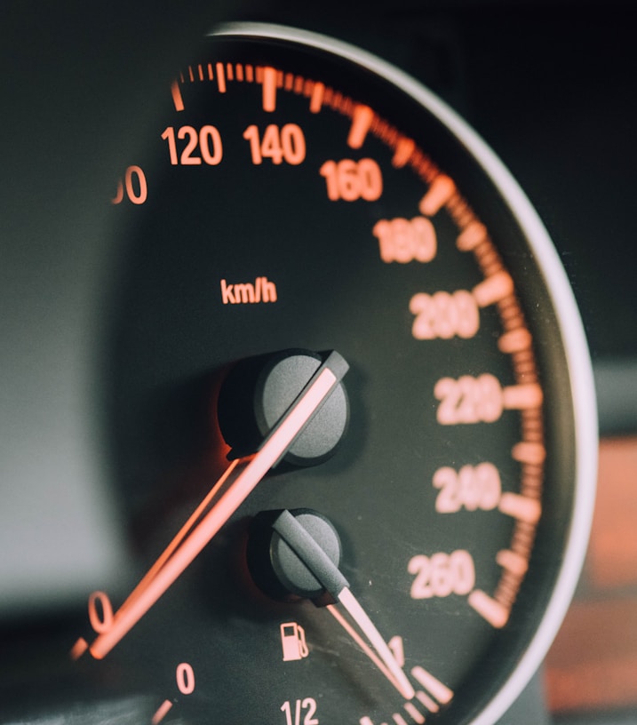 closeup photo of black analog speedometer