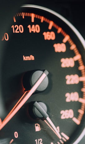 closeup photo of black analog speedometer