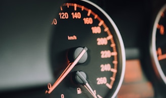 closeup photo of black analog speedometer