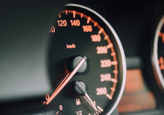 closeup photo of black analog speedometer