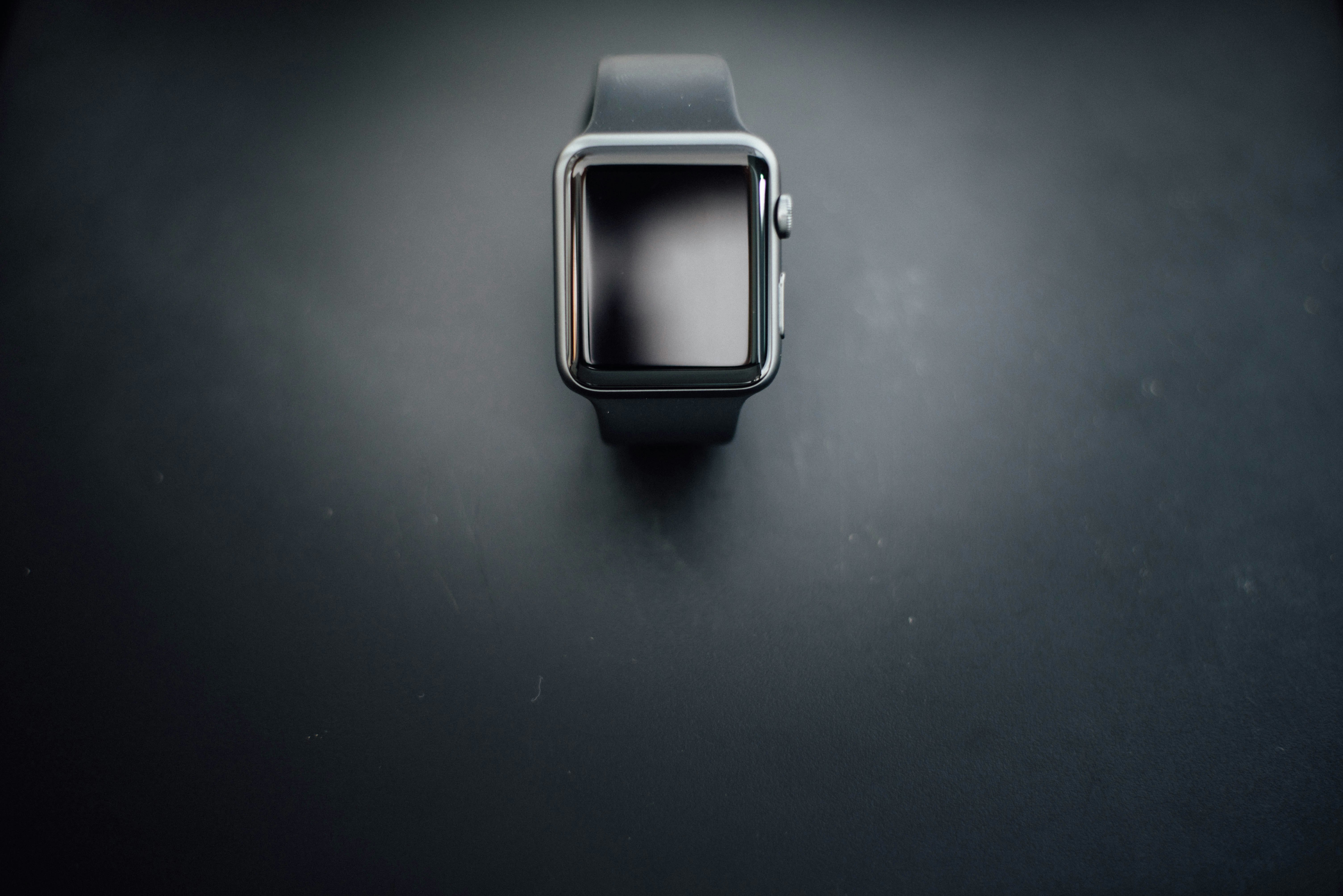 shallow focus photography of silver Apple Watch with black Sport Band