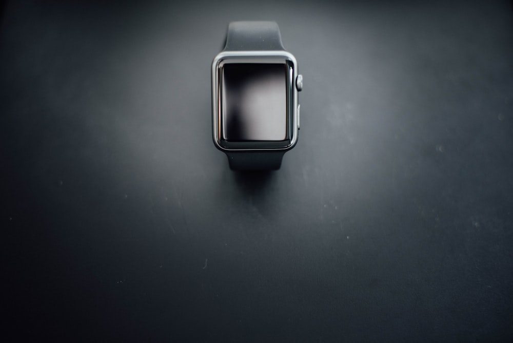 shallow focus photography of silver Apple Watch with black Sport Band