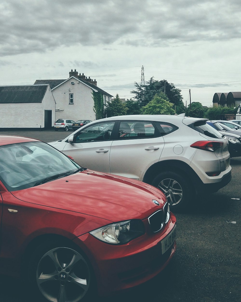 Red and white cars parked.