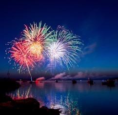 green, red, and white fireworks on sky at nighttime