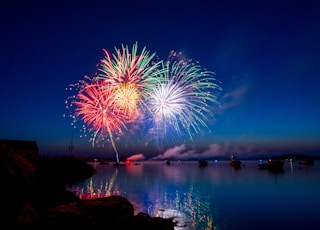 green, red, and white fireworks on sky at nighttime