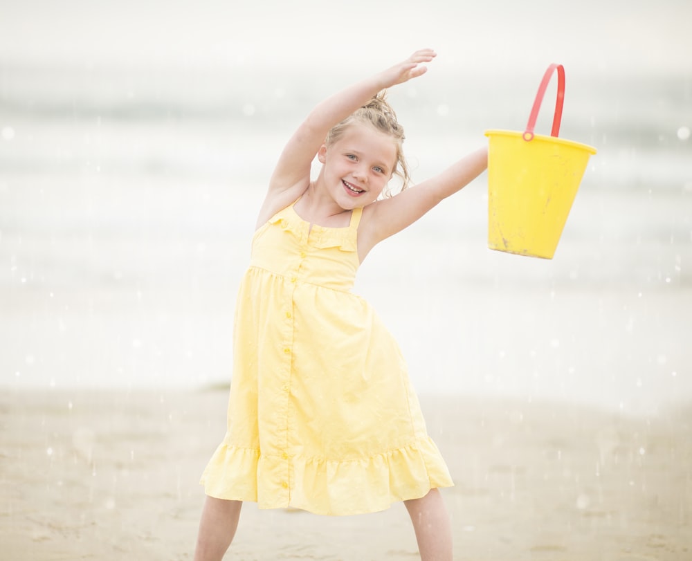 selective focus photography of girl standing near sea shore