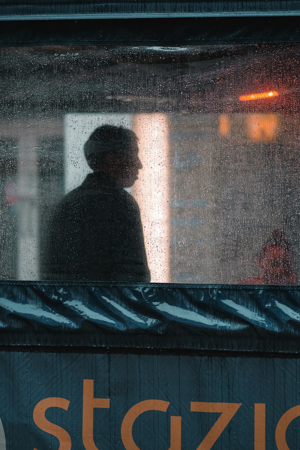 man standing near white concrete building