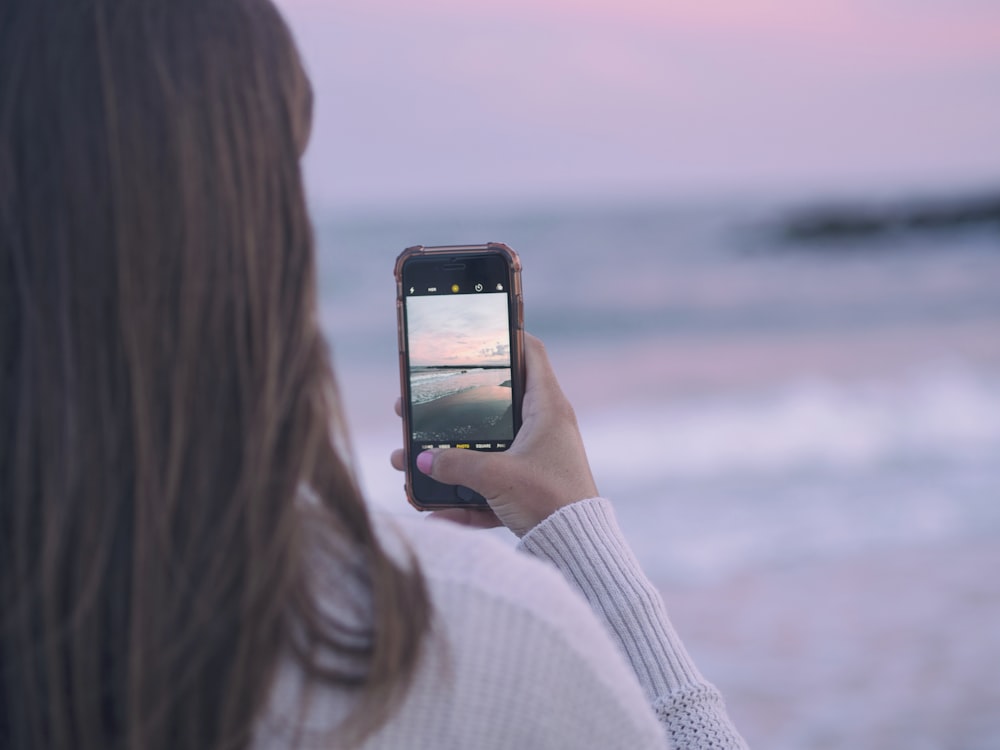 woman capturing image using her smartphone