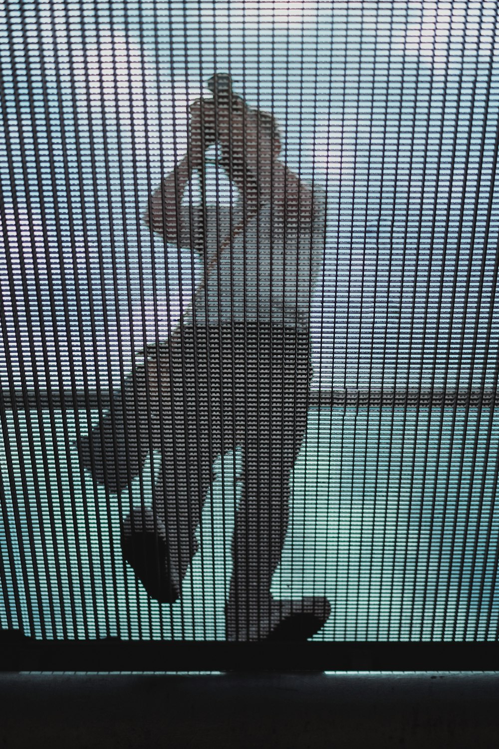 low-angle photography of man standing on a screen ceiling